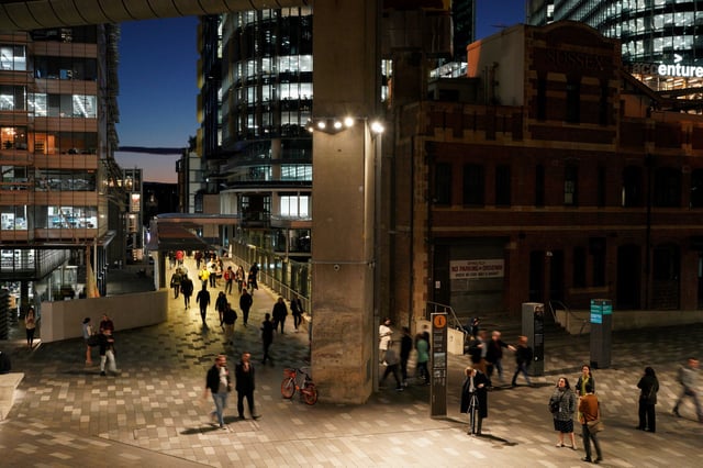 People walk through the Central Business District (CBD) at dusk in Sydney, Australia, June 4, 2021.  REUTERS/Loren Elliott/File Photo