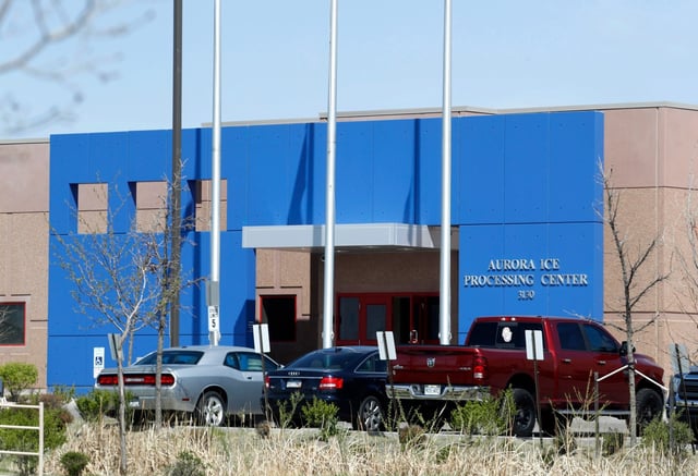 In this April 15, 2017, file photo, vehicles are parked outside the entrance to the GEO Group&#39;s immigrant detention facility in Aurora, Colo. Denver officials have refused to renew more than $10 million in contracts for halfway houses with two of the nation&#39;s largest corrections companies partly due to their track record operating immigration detention facilities. City councilors voted Monday night to walk away from the deals with GEO Group and CoreCivic. The city council&#39;s decision will have no impact on the facility in Aurora.