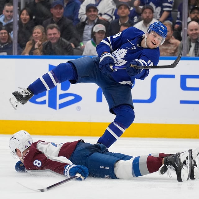 Mar 19, 2025; Toronto, Ontario, CAN; Toronto Maple Leafs forward Steven Lorentz (18) scores the winning goal over a sprawled Colorado Avalanche defenseman Cale Makar (8) during the third period at Scotiabank Arena. Mandatory Credit: John E. Sokolowski-Imagn Images
