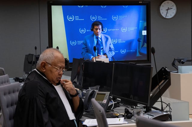 Former Philippine President Rodrigo Duterte is seen on a screen in the courtroom of the International Criminal Court (ICC) with his lawyer Salvador Medialdea seated left, in The Hague, Netherlands, Friday, March 14, 2025. Peter Dejong/Pool via REUTERS/File Photo