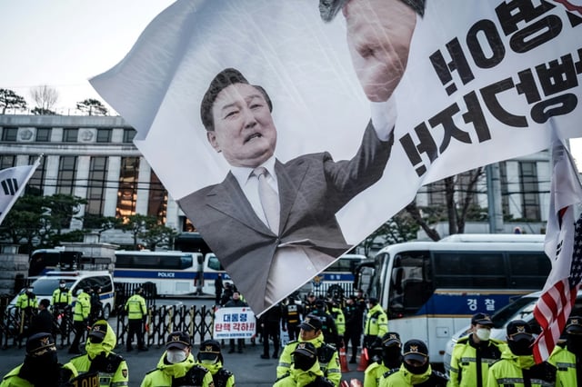 A flag displaying impeached South Korean President Yoon Suk Yeol is seen as his supporters hold a rally in front of the Constitutional Court in Seoul