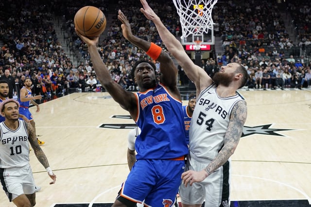Mar 19, 2025; San Antonio, Texas, USA; New York Knicks forward OG Anunoby (8) drives to the basket against San Antonio Spurs forward Sandro Mamukelashvili (54) during the second half at Frost Bank Center. Mandatory Credit: Scott Wachter-Imagn Images