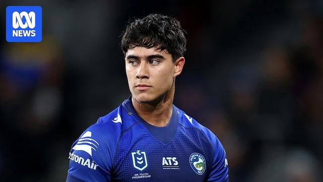 a rugby player looks over his shoulder and walks 