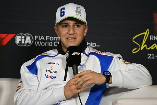 RB's French driver Isack Hadjar talks to reporters in Shanghai