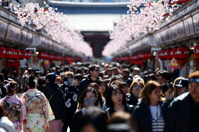 Visitors walk along Nakamise-dori street as they visit Sensoji temple at Asakusa district, a popular sightseeing spot in Tokyo, Japan March 10, 2025. REUTERS/Issei Kato