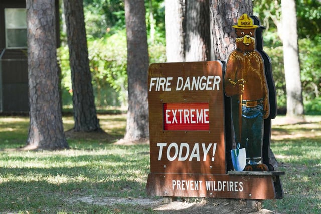 A Smokey the Bear sign warns of fire potential conditions at Sam Houston National Forest in New Waverly on Tuesday, July 19, 2022.