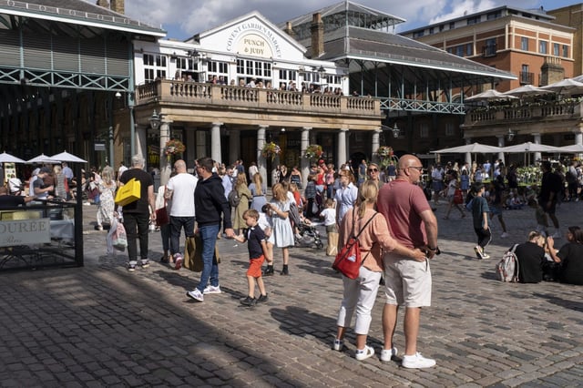 Visitors enjoy the area around Covent Garden&#39;s piazza.