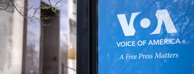 Signage for US broadcaster Voice of America is seen in Washington, DC, on March 16, 2025. US President Donald Trump's administration on March 15 put journalists at Voice of America and other US-funded broadcasters on leave, abruptly freezing decades-old outlets long seen as critical to countering Russian and Chinese information offensives. (Photo by BONNIE CASH/AFP via Getty Images)