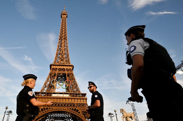 French police officers in front of the Eiffel Tower in Paris on July.