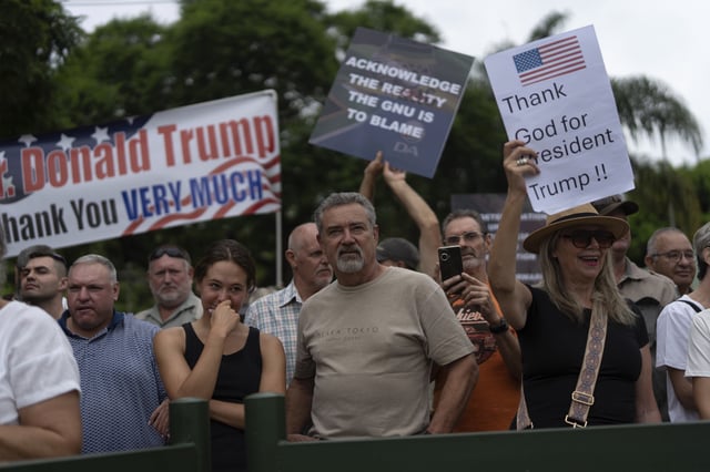 FILE - White South Africans demonstrate in support of U.S. President Donald Trump in front of the U.S. embassy in Pretoria, South Africa, Feb. 15, 2025. (AP Photo/Jerome Delay, File)