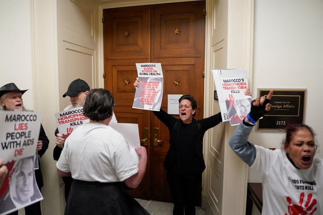 Protesters hold placards as Pete Marocco, deputy administrator-designate at the U.S. Agency for International Development (USAID), attends a meeting with members of Congress to discuss foreign assistance, on Capitol Hill in Washington, D.C., U.S. March 5, 2025.