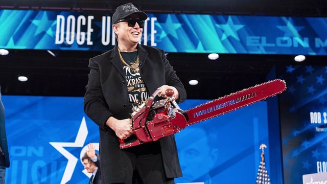 Elon Musk, holding a chainsaw at a conservative political event in February, is overseeing federal spending cuts in the US as the head of the Department of Government Efficiency