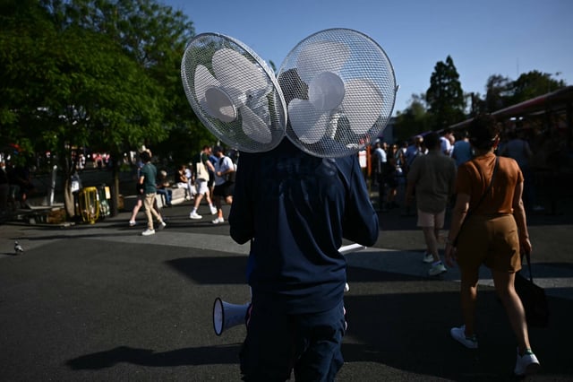 Un bénévole achemine des ventilateurs sur un site olympique pendant les JO de Paris, le 29 juillet 2024.