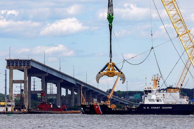 A U.S. Coast Guard boat approaches clean-up operations at the Francis Scott Key Bridge as the main shipping channel prepares to fully reopen, in Baltimore, Maryland, U.S., June 10, 2024. REUTERS/Evelyn Hockstein/File Photo