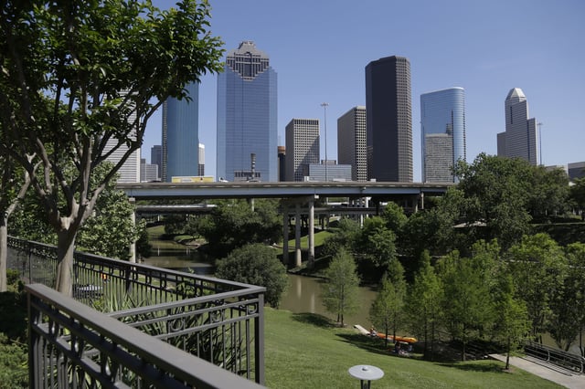 FILE - The Houston skyline overlooks the Buffalo Bayou as it snakes its' way into downtown Friday, April 18, 2014. (AP Photo/Pat Sullivan,File)