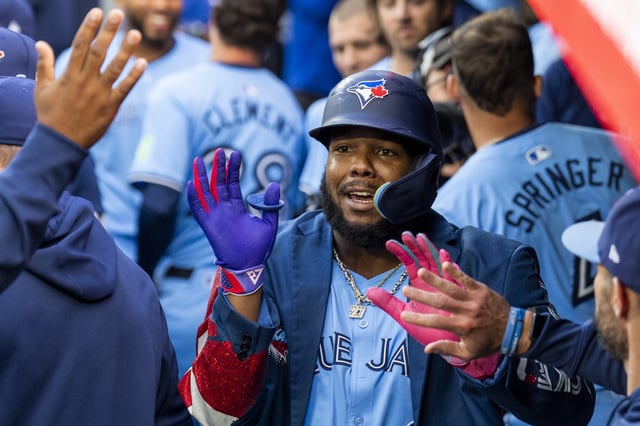 TORONTO, CANADA - AUGUST 19: Vladimir Guerrero Jr. #27 of the Toronto Blue Jays celebrates with teammates after hitting a home run against the Cincinnati Reds during the first inning in their MLB game at Rogers Centre on August 19, 2024 in Toronto, Canada.