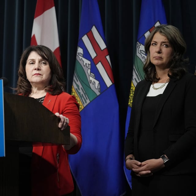 Alberta Health Minister Adriana LaGrange (L) and Alberta Premier Danielle Smith listens to questions at a news conference in Calgary, Alberta February 19, 2025. Todd Korol/The Globe and Mail