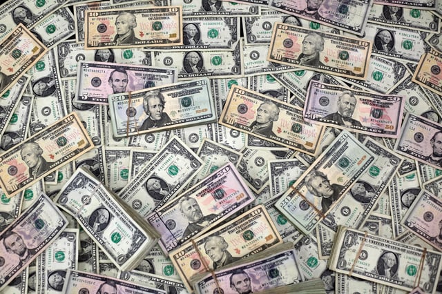 U.S. dollar banknotes are seen in this photo illustration taken February 12, 2018. REUTERS/Jose Luis Gonzalez/Illustration/File Photo