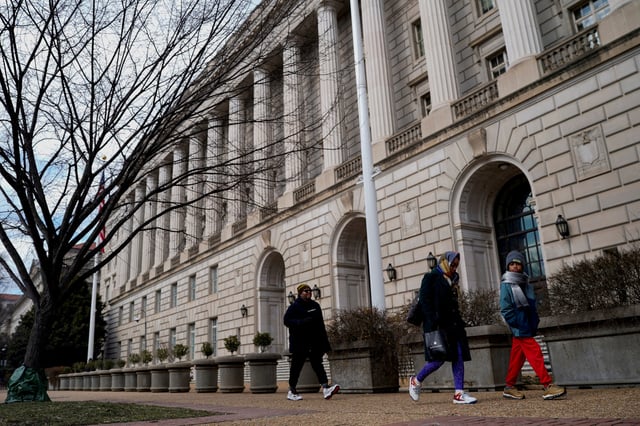 People walk by the U.S. Internal Revenue Service (IRS) building in Washington, D.C., February 20, 2025. REUTERS/Kent Nishimura/File Photo