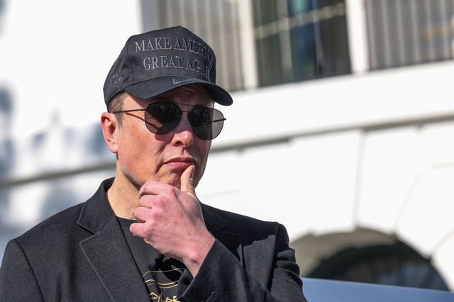 Elon Musk looks on as President Donald Trump addresses the media, at the White House on March 11, 2025.