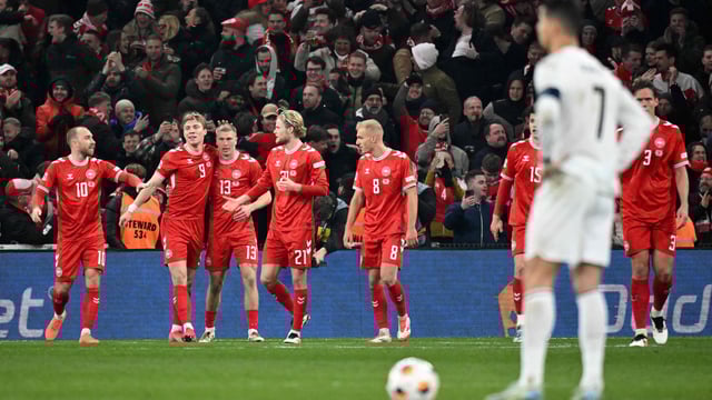 Portugal's forward Cristiano Ronaldo (front R) reacts as Denmark's players celebrate.