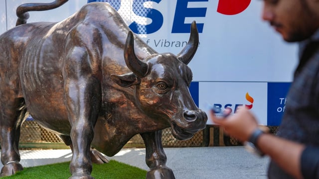 Sensex, Nifty 50 today: A man walks past the bull statue at BSE building in Mumbai.