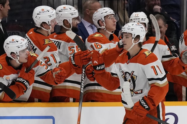 Ducks center Trevor Zegras (11) celebrates with teammates as he skates past the bench after scoring a goal during the second period of their game against the Nashville Predators on Thursday night in Nashville, Tenn. (AP Photo/George Walker IV)
