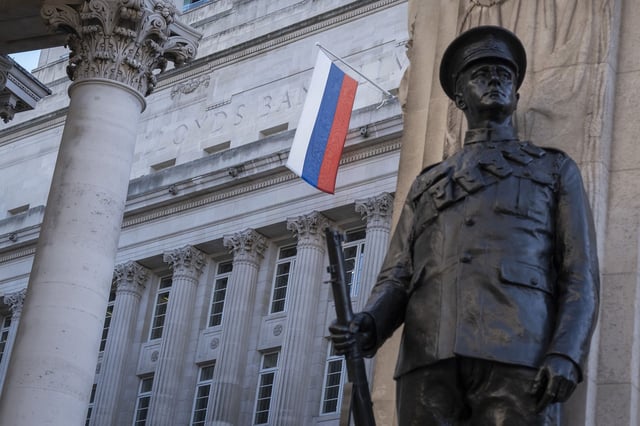The Russian flag hangs from Russian investment Bank VTB Capital in London, above a memorial to World War I British war dead, on January 31, 2022, less than a month before Russia's full-scale invasion.