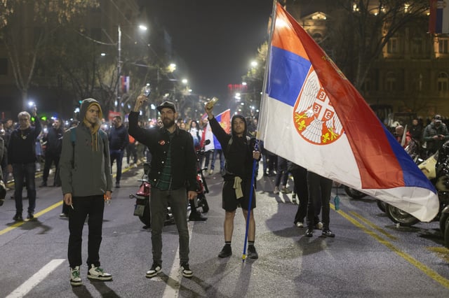 People use the lights on their cell phones as they observe fifteen minutes of silence during a major anti-corruption rally led by university students in Belgrade, Serbia, Saturday, March 15, 2025. (AP Photo/Marko Drobnjakovic)
