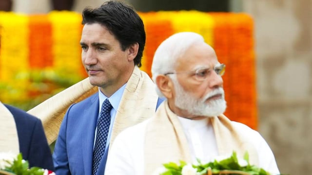 Former Canadian PM Justin Trudeau walks past Prime Minister Narendra Modi during the G20 Summit in New Delhi in September 2023. (AP File Photo)