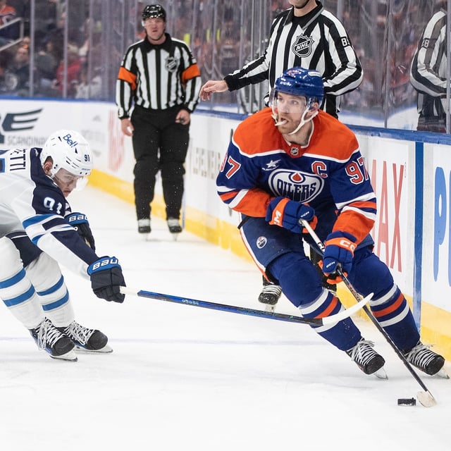 Winnipeg Jets' Cole Perfetti (91) chases Edmonton Oilers' Connor McDavid (97) during second-period NHL action in Edmonton on Thursday, March 20, 2025. THE CANADIAN PRESS/Jason Franson