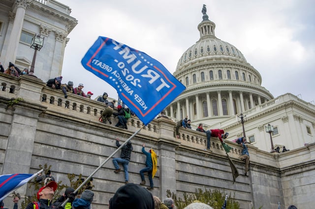 Support of President Donald Trump climb the West wall of the the U.S. Capitol, Jan. 6, 2021.