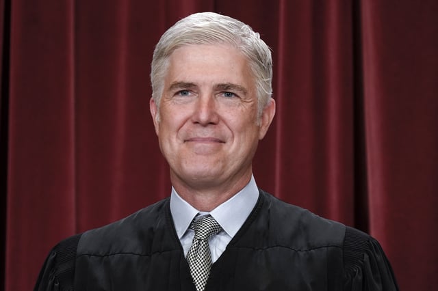 Supreme Court Justice Neil Gorsuch poses for a new group portrait, at the Supreme Court building in Washington, Friday, Oct. 7, 2022.
