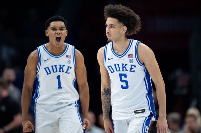 Caleb Foster #1 of the Duke Blue Devils celebrates with Tyrese Proctor #5 in the first half against the Louisville Cardinals during the championship round of the ACC men&#39;s basketball tournament at Spectrum Center on March 15, 2025 in Charlotte, North Carolina.