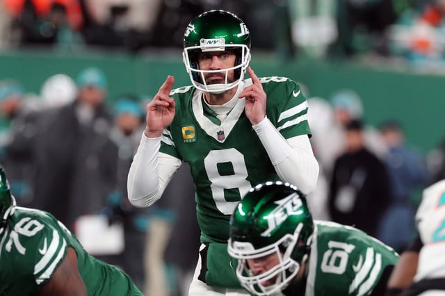 Quarterback Aaron Rodgers #8 of the New York Jets follows the action in the game between the Miami Dolphins against the New York Jets at MetLife Stadium on January 5, 2025.