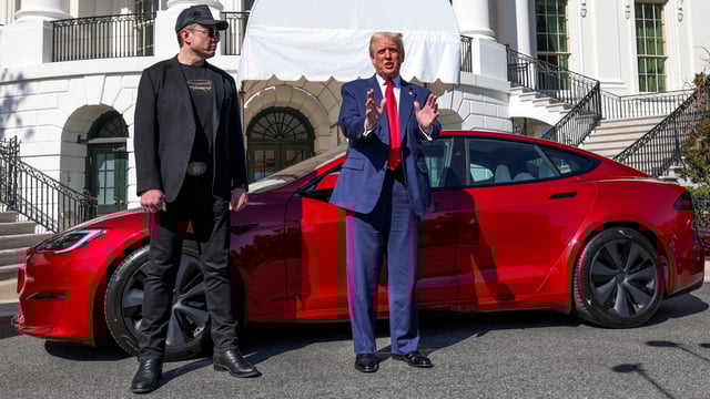 US President Donald Trump talks to the media next to Tesla CEO Elon Musk.