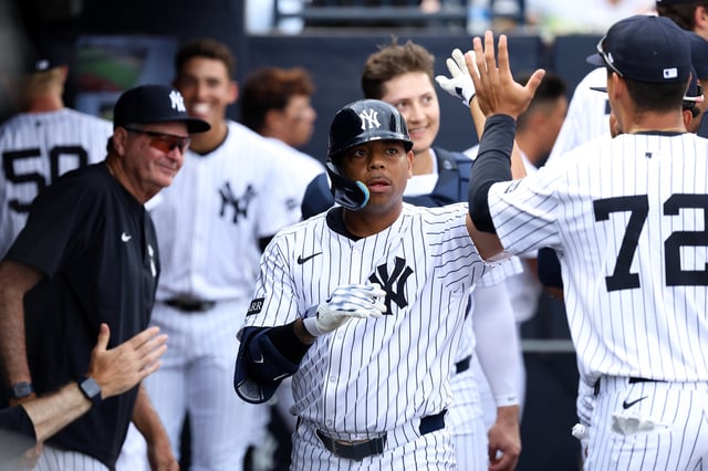 Dominic Smith #22 of the New York Yankees high fives teammates during spring training at George M. Steinbrenner Field on March 16, 2025 in Tampa, Florida.