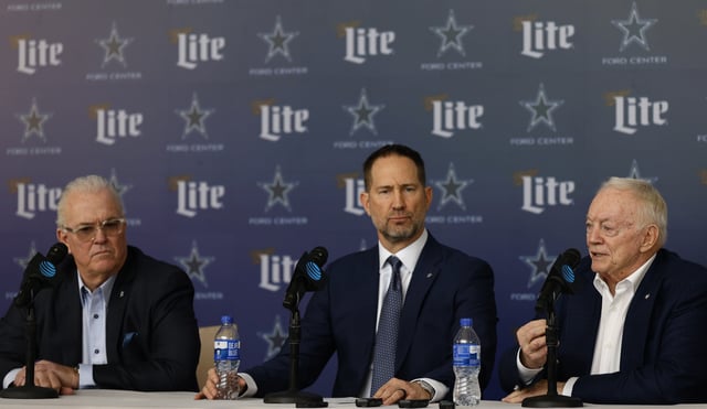 New head coach of the Dallas Cowboys Brian Schottenheimer looks on during at a press conference along side CEO and Executive Vice President Stephen Jones and team owner Jerry Jones.