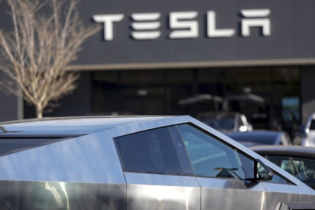 A Tesla Cybertruck and other Telsla vehicles sit at a dealership in Kennesaw, Ga., on Wednesday, March 19, 2025.