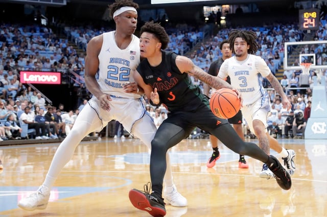 Miami guard Jalil Bethea (3) drives against North Carolina forward Ven-Allen Lubin (22) during the second half of an NCAA college basketball game Saturday, March 1, 2025, in Chapel Hill, N.C. (AP Photo/Chris Seward)