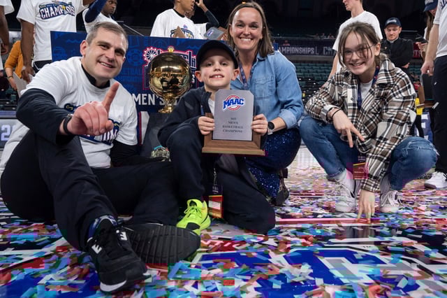 Mount St. Mary&#39;s head coach Donny Lind poses with his family and the MAAC Trophy following the NCAA college basketball game in the championship of the Metro Atlantic Athletic Conference tournament against Iona, Saturday, March 15, 2025, in Atlantic City, N.J. Mount St Mary&#39;s won 63-49. (AP Photo/Chris Szagola)
