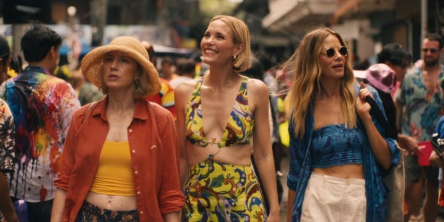 Carrie Coon, Leslie Bibb and Michelle Monaghan walk in market street in The White Lotus Season 3, Episode 4.