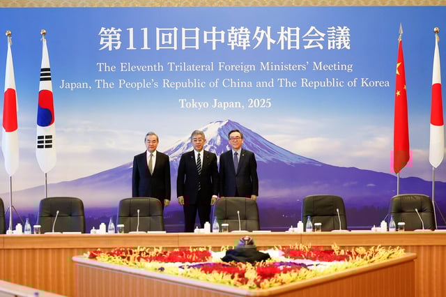 Chinese Foreign Minister Wang Yi, Japanese Foreign Minister Takeshi Iwaya and South Korean Foreign Minister Cho Tae-yul pose for the cameras during the 11th Trilateral Foreign Minister’s Meeting (Japan-China-ROK) in Tokyo on March 22, 2025, Japan.     Rodrigo Reyes Marin/Pool via REUTERS