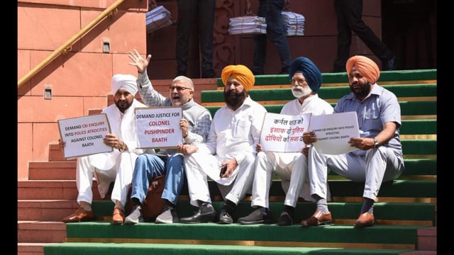 Congress MPs Dharamvira Gandhi, Charanjit Singh Channi, Sher Singh Ghubaya along with other party MPs hold a protest demanding justice for Colonel Pushpinder Singh Bath at Parliament during the budget session in New Delhi on Friday. (ANI)