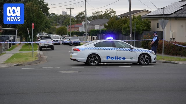 nsw police officers and cars at a crime scne on Crossland Street, Merrylands after shots were fired at a house