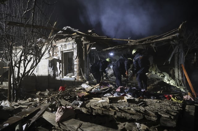 Rescue workers clear the rubble of a residential house destroyed by a Russian drone strike in Zaporizhzhia, Ukraine, Friday, March 21, 2024. (AP Photo/Kateryna Klochko)