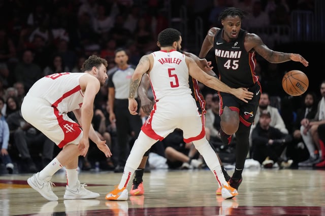 Mar 21, 2025; Miami, Florida, USA;  Miami Heat guard Davion Mitchell (45) loses control of the ball as Houston Rockets guard Fred VanVleet (5) closes in during the second half at Kaseya Center. Mandatory Credit: Jim Rassol-Imagn Images