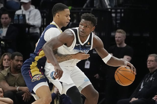 Mar 21, 2025; Minneapolis, Minnesota, USA; Minnesota Timberwolves guard Anthony Edwards (5) works against New Orleans Pelicans guard Jordan Hawkins (24) in the third quarter at Target Center. Mandatory Credit: Bruce Kluckhohn-Imagn Images