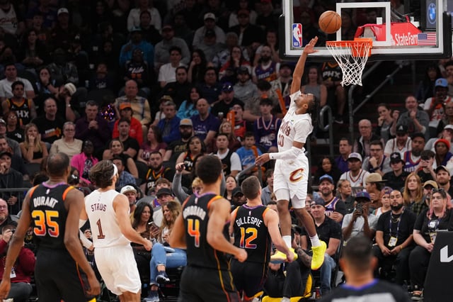 Mar 21, 2025; Phoenix, Arizona, USA; Cleveland Cavaliers guard Darius Garland (10) puts up a layup against the Phoenix Suns during the second half at Footprint Center. Mandatory Credit: Joe Camporeale-Imagn Images