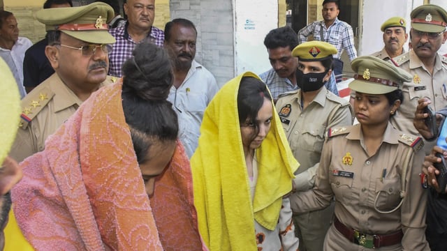 Police take away Merchant Navy officer Saurabh Rajput's wife Muskaan and her lover Sahil Shukla after they were arrested in connection with his murder, in Meerut, on March 19, 2025. 